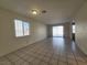 Living area with tile flooring and sliding glass door to backyard at 725 Brick Dr, Henderson, NV 89002