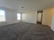 Spacious living room with neutral walls and grey carpet at 725 Brick Dr, Henderson, NV 89002