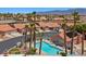 Palm Springs community aerial showcasing homes with pools, palm trees, and mountain views at 731 Appletree Ln, Mesquite, NV 89027