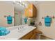 This bathroom includes a white counter, wood cabinets, and a tiled floor at 731 Appletree Ln, Mesquite, NV 89027