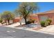 View of the home showcasing the landscaping, security gate, two-car garage, and desert landscaping in the front yard at 731 Appletree Ln, Mesquite, NV 89027