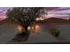 Charming single-Gathering home with attached garage, tile roof, desert landscaping, and a view of the vibrant sunset sky at 731 Appletree Ln, Mesquite, NV 89027