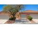 Exterior view of a single-Gathering home showing landscaping, garage, and charming entry with a security gate at 731 Appletree Ln, Mesquite, NV 89027