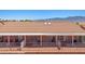 Exterior showing backyard patios, terracotta tile roof, white aluminum pergolas and a brick retaining wall at 731 Appletree Ln, Mesquite, NV 89027