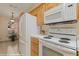 Kitchen showing white appliances including a stove, refrigerator, and microwave at 731 Appletree Ln, Mesquite, NV 89027