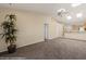 Open-concept living space with neutral carpet and views of the kitchen at 731 Appletree Ln, Mesquite, NV 89027