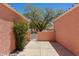 Cozy patio area with a charming gate, offering a serene outdoor space and some landscaping at 731 Appletree Ln, Mesquite, NV 89027