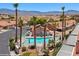 Aerial view of community pool with palm trees, and desert landscape at 731 Appletree Ln, Mesquite, NV 89027