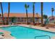 Community pool with lounge seating and fencing for privacy at 731 Appletree Ln, Mesquite, NV 89027