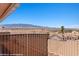 Enjoy the desert view from this home's backyard patio and white metal fence surround at 731 Appletree Ln, Mesquite, NV 89027