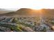 Breathtaking aerial view of a residential community nestled against the backdrop of majestic mountains at sunset at 741 Canary Wharf Dr, Las Vegas, NV 89178