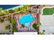 Stunning aerial view of a backyard showcasing a custom pool with rock features, lush landscaping, and ample space for recreation at 741 Canary Wharf Dr, Las Vegas, NV 89178