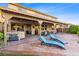 Spacious backyard featuring a covered patio, lounge chairs, a hot tub, and access to a sparkling pool, perfect for outdoor living at 741 Canary Wharf Dr, Las Vegas, NV 89178