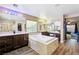 Open bathroom with a soaking tub, dual vanities, and vanity area at 741 Canary Wharf Dr, Las Vegas, NV 89178