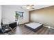Bright bedroom with ceiling fan, wood-look floors, and a view of the exterior at 741 Canary Wharf Dr, Las Vegas, NV 89178