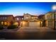 Charming home with a three-car garage, manicured landscaping, and warm exterior lighting, offering curb appeal and convenience at 741 Canary Wharf Dr, Las Vegas, NV 89178