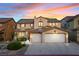 Two-story home exterior with a tile roof, two-car garage, and beautiful twilight sky at 741 Canary Wharf Dr, Las Vegas, NV 89178