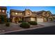 Inviting home exterior features a two-car garage, tile roof, and desert landscaping at 741 Canary Wharf Dr, Las Vegas, NV 89178
