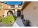 Charming home exterior featuring a well-maintained lawn and a welcoming front porch, potted plant and rock landscaping at 741 Canary Wharf Dr, Las Vegas, NV 89178