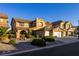 Lush exterior of a two-story home with a tile roof, two-car garage, and desert landscaping at 741 Canary Wharf Dr, Las Vegas, NV 89178