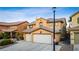 Beautiful home exterior with a two-car garage, well-manicured lawn, and inviting curb appeal at 741 Canary Wharf Dr, Las Vegas, NV 89178