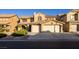 Attractive home exterior features a two-car garage, tile roof, and desert landscaping at 741 Canary Wharf Dr, Las Vegas, NV 89178