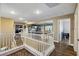Upstairs hallway with wood floors and white railings overlooks the entertainment room at 741 Canary Wharf Dr, Las Vegas, NV 89178