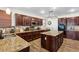 Bright kitchen featuring dark cabinets, granite countertops, stainless steel appliances, and a central island at 741 Canary Wharf Dr, Las Vegas, NV 89178