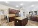 Bright kitchen featuring dark cabinets, granite countertops, stainless steel appliances, and a central island at 741 Canary Wharf Dr, Las Vegas, NV 89178