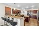 Bright kitchen featuring dark cabinets, granite countertops, stainless steel appliances, bar and a central island at 741 Canary Wharf Dr, Las Vegas, NV 89178