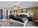 Spacious main bedroom featuring wood floors, a ceiling fan, and a decorative rug at 741 Canary Wharf Dr, Las Vegas, NV 89178