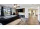 Bright main bedroom with a large window, TV, and wood floors at 741 Canary Wharf Dr, Las Vegas, NV 89178