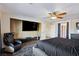 Bright main bedroom with a large TV, chair, and ensuite bathroom at 741 Canary Wharf Dr, Las Vegas, NV 89178