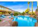 Inviting pool area with rock features, swaying palm trees, and a covered patio, ideal for relaxing and entertaining outdoors at 741 Canary Wharf Dr, Las Vegas, NV 89178