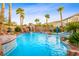 Stunning pool featuring a rock waterfall and lush landscaping, offering a serene and private backyard oasis at 741 Canary Wharf Dr, Las Vegas, NV 89178