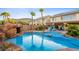 Beautiful pool with a rock grotto and lush landscaping, perfect for relaxing and entertaining in a private backyard setting at 741 Canary Wharf Dr, Las Vegas, NV 89178