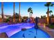Stunning swimming pool with rock waterfall feature, and dolphin art in a tranquil outdoor space at 741 Canary Wharf Dr, Las Vegas, NV 89178