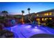 Enjoy a refreshing dip in the luxurious pool, complete with a waterfall, rock features, and swaying palm trees at 741 Canary Wharf Dr, Las Vegas, NV 89178