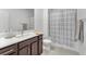 Modern bathroom featuring a vanity with white countertop and neutral-colored shower curtain at 752 Echelon St, Las Vegas, NV 89138