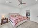 Bright bedroom featuring a comfy bed, ceiling fan, and adjacent walk-in closet for ample storage at 752 Echelon St, Las Vegas, NV 89138
