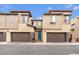 Modern townhouse featuring a blue door, brown trim, and attached garages, inviting curb appeal and practical design at 752 Echelon St, Las Vegas, NV 89138