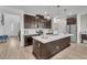 Spacious kitchen featuring a large island, modern appliances, and stylish dark wood cabinetry, perfect for cooking at 752 Echelon St, Las Vegas, NV 89138