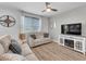 Inviting living room features modern furniture, a ceiling fan, and an electric fireplace for a cozy atmosphere at 752 Echelon St, Las Vegas, NV 89138