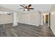 Bedroom with a ceiling fan, mirrored closet doors, and wood-look flooring at 808 Vermillion Dr, Henderson, NV 89002