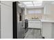 Modern kitchen featuring stainless steel appliances, bright white cabinets, and sleek countertops at 808 Vermillion Dr, Henderson, NV 89002