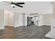 Spacious living room with open floor plan, modern kitchen with stainless steel appliances, and inviting fireplace at 808 Vermillion Dr, Henderson, NV 89002