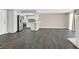 Inviting living area featuring sleek gray wood floors, a modern kitchen with stainless steel appliances, and a fireplace at 808 Vermillion Dr, Henderson, NV 89002