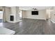 Bright living room showcasing gray wood floors, a cozy fireplace, and ample space for entertaining and relaxation at 808 Vermillion Dr, Henderson, NV 89002