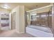 Bathroom view showcasing a clear glass-enclosed shower/tub combination and modern fixtures at 8316 Accolade St, Las Vegas, NV 89139