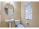 Cozy powder bathroom with a pedestal sink and toilet at 8316 Accolade St, Las Vegas, NV 89139